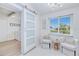 Cozy sitting area with two armchairs, a side table, and a barn door leading to laundry at 148 Salem Nw Ave, Port Charlotte, FL 33952