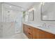 Elegant bathroom featuring double vanity and marble shower at 1511 Casey Key Dr, Punta Gorda, FL 33950