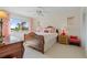 Bedroom with antique bed, water view, and coral accents at 1511 Casey Key Dr, Punta Gorda, FL 33950