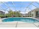 Inviting kidney-shaped pool with a screened enclosure and canal views at 1511 Casey Key Dr, Punta Gorda, FL 33950