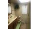 Bathroom with double vanity, toilet, and exterior access at 15570 Rasmussen Rd, Punta Gorda, FL 33982