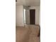 Empty carpeted bedroom with closet and bathroom access at 15570 Rasmussen Rd, Punta Gorda, FL 33982