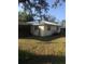 Side view of a single-story house with a grassy yard at 15570 Rasmussen Rd, Punta Gorda, FL 33982