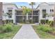 Front view of a two-story building with screened balconies and courtyard at 15960 Grassland Ln # 2722, Punta Gorda, FL 33982