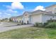 Row of attached garages with paved pathway and landscaping at 15960 Grassland Ln # 2722, Punta Gorda, FL 33982