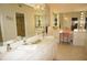 Elegant bathroom with double vanity, large mirror and seating area at 1601 Park Beach Cir # 136/18, Punta Gorda, FL 33950