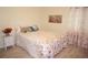 Bedroom with floral bedding and nightstand at 1601 Park Beach Cir # 136/18, Punta Gorda, FL 33950