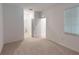 Well-lit bedroom featuring carpet floors and an ensuite bathroom at 17565 Opal Sand Dr # 401, Venice, FL 34293