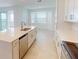 Kitchen island with double sink and stainless steel dishwasher at 17565 Opal Sand Dr # 401, Venice, FL 34293