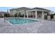 Community pool with brick pavers and covered seating area at 17565 Opal Sand Dr # 401, Venice, FL 34293