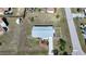 Direct overhead aerial view of a single story house with a landscaped front yard at 18086 Clanton Ave, Port Charlotte, FL 33948