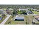 Aerial view of a single-story house with fenced backyard in a residential neighborhood at 18086 Clanton Ave, Port Charlotte, FL 33948