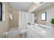 Clean bathroom with a shower/tub combo, white vanity, and a large mirror at 18086 Clanton Ave, Port Charlotte, FL 33948