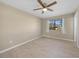 Spacious bedroom with ceiling fan and window at 18086 Clanton Ave, Port Charlotte, FL 33948