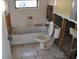 Bathroom with damaged walls, tub, and toilet at 201 Winson Ave, Englewood, FL 34223