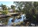 Waterfront view of canal with a home and dock at 201 Winson Ave, Englewood, FL 34223