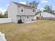 Large backyard with patio and grill, next to a fenced yard at 22116 Seaton Ave, Port Charlotte, FL 33954