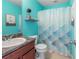 Charming teal bathroom with shower and small vanity at 22116 Seaton Ave, Port Charlotte, FL 33954