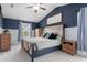 Main bedroom with tufted headboard, wood nightstands, and dark blue walls at 22116 Seaton Ave, Port Charlotte, FL 33954