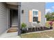 Front door entry with stairs, small sitting area, and landscaping at 22116 Seaton Ave, Port Charlotte, FL 33954