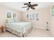 Bedroom with a queen-size bed, ceiling fan, and tiled floors at 2341 W Marion Ave, Punta Gorda, FL 33950