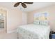 Bedroom with a queen bed, tiled floors, and access to a bathroom at 2341 W Marion Ave, Punta Gorda, FL 33950