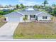 Single-story home with a tile roof, attached garage, and well-manicured lawn at 2341 W Marion Ave, Punta Gorda, FL 33950