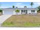 Single story home with attached garage, landscaping and palm trees at 2341 W Marion Ave, Punta Gorda, FL 33950