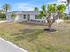 Single story home with attached garage and mature landscaping at 2341 W Marion Ave, Punta Gorda, FL 33950