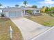 Single story home with attached garage, landscaping and mailbox at 2341 W Marion Ave, Punta Gorda, FL 33950