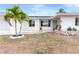 Single story home with attached garage, landscaping and palm trees at 2341 W Marion Ave, Punta Gorda, FL 33950