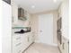 White kitchen with gas cooktop and stainless steel range hood at 2341 W Marion Ave, Punta Gorda, FL 33950