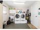 Bright laundry room with washer, dryer, and storage at 2341 W Marion Ave, Punta Gorda, FL 33950