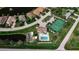 Aerial view of RioVilla Lakes community, showcasing homes, pool, tennis courts, and landscaping at 24667 Rio Villa Lakes Cir, Punta Gorda, FL 33950