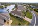 Aerial view of house and surrounding neighborhood with lake view at 24667 Rio Villa Lakes Cir, Punta Gorda, FL 33950