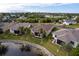 Aerial view showcasing a house near a lake in a residential area at 24667 Rio Villa Lakes Cir, Punta Gorda, FL 33950