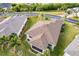 Aerial view of house with brown roof and screened porch at 24667 Rio Villa Lakes Cir, Punta Gorda, FL 33950