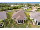 Aerial view of house showing a screened porch and surrounding landscape at 24667 Rio Villa Lakes Cir, Punta Gorda, FL 33950