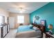 Spacious bedroom with a king-size bed and teal walls at 24667 Rio Villa Lakes Cir, Punta Gorda, FL 33950