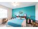 King-size bedroom, teal walls, and ceiling fan at 24667 Rio Villa Lakes Cir, Punta Gorda, FL 33950