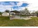 Relaxing bocce ball court with covered seating area and adjacent pond at 24667 Rio Villa Lakes Cir, Punta Gorda, FL 33950