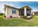 House exterior showcasing a screened porch and well-manicured lawn at 24667 Rio Villa Lakes Cir, Punta Gorda, FL 33950