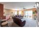 Relaxing living room with leather couches and access to the balcony at 24667 Rio Villa Lakes Cir, Punta Gorda, FL 33950