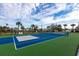 Well-maintained tennis court with green and blue surface, ready for play at 24667 Rio Villa Lakes Cir, Punta Gorda, FL 33950