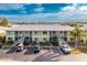 Aerial view of a condo building with parking and water access at 25225 Rampart Blvd # 1701, Punta Gorda, FL 33983