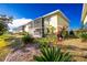 Building exterior with lush landscaping and screened patio at 25225 Rampart Blvd # 1701, Punta Gorda, FL 33983