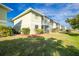 Building exterior showcasing a well-maintained lawn and landscaping at 25225 Rampart Blvd # 1701, Punta Gorda, FL 33983