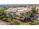 Aerial view showcasing the building's location, landscaping, and nearby tennis court at 255 W End Dr # 3301, Punta Gorda, FL 33950