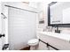 Clean bathroom with white vanity, black accents, and striped shower curtain at 29350 Goodhue St, Punta Gorda, FL 33982