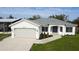 White house with gray metal roof and attached garage at 29350 Goodhue St, Punta Gorda, FL 33982